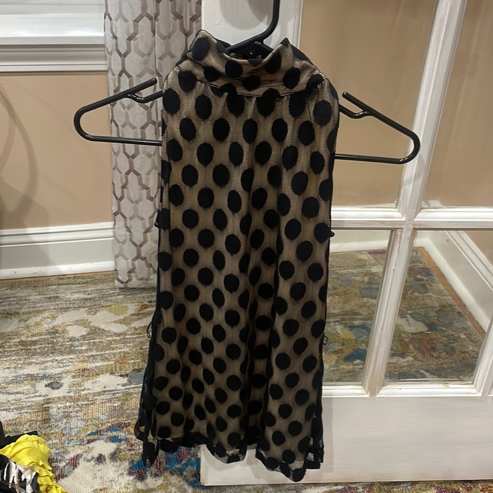 Cream color cami with large black polka dots. High neck and open back.